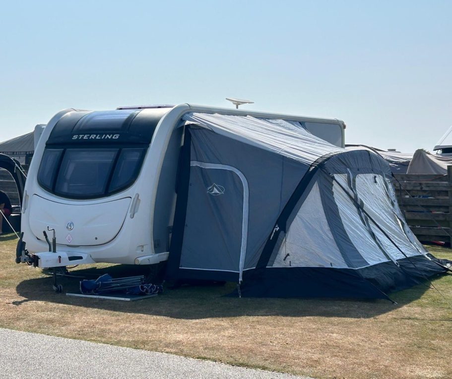 SquaredAway touring caravan professionally set up with a full awning for a customer stay.